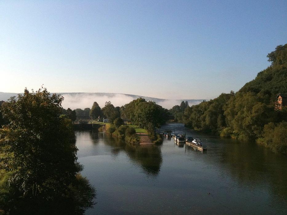Beautiful landscape of the river, among the colorful plants, in clouds