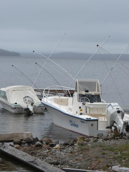 Boats on the coast of Moosehead Lake in USA, under the clouds