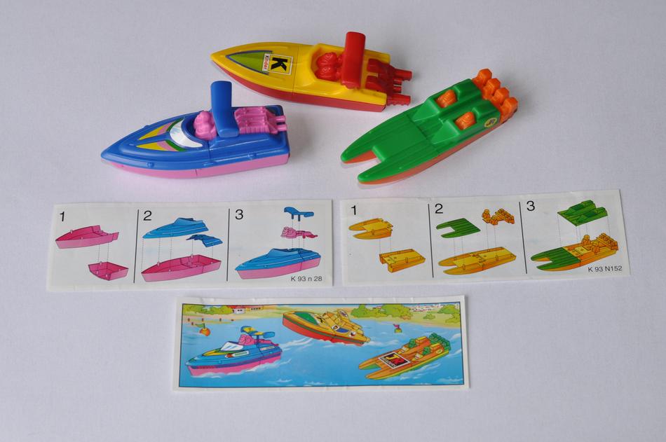 Colorful boat toys with images, on the white surface