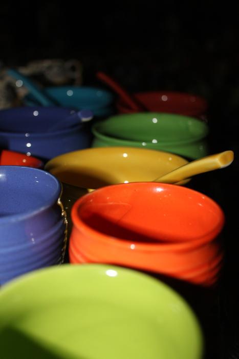 ceramic bowls of different colors in the dark