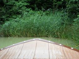 sailing from the shore, wooden bow of the boat