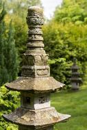 stone lantern in a japanese garden near the trees