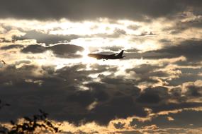 Aircraft silhouette at dramatic sunset sky