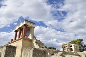 Beautiful and colorful Knossos with columns, in Crete, Greece, under the blue sky with clouds