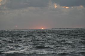 setting sun on the horizon of the north sea at dusk