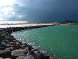 Beautiful cape with stones, under the clouds