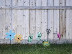 Windy Flowers Toys In Front Of The Fence