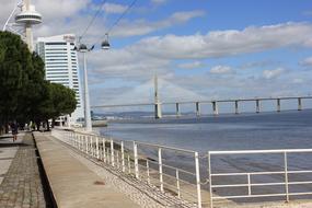 Landscape with the bridge, from the coast of Lisbon, Portugal, with buildings