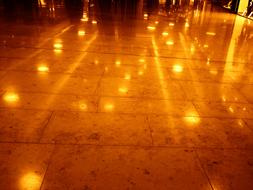 Close-up of the shiny tiles, with reflections of the lights