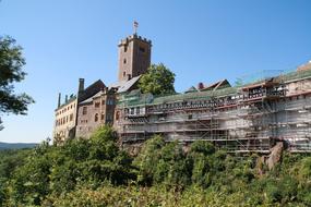 Beautiful and colorful landscape with the Wartburg Castle among the colorful plants, in Germany, under the blue sky