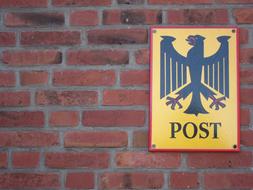 Shield Post on a brick wall close-up