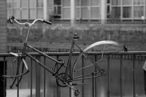 Black and white photo with the bike with no wheels, near the water, in Hamburg, Germany