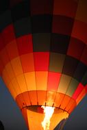 flames in a colorful hot air balloon in the dark close up