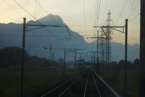 Beautiful landscape with the railway, near the mountains, in Switzerland, at colorful and beautiful sunset