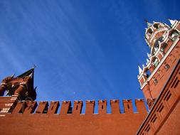 Beautiful Kremlin with Spasskaya Tower, in Moscow, Russia, under the blue sky with clouds