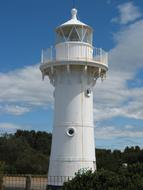 white lighthouse on a clear sunny day close-up