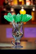 green candy sticks in Glass