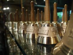 Shiny bells in the shop in Villedieu-Les-Poeles in France