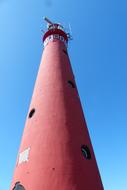 lighthouse with pink walls on the sea coast