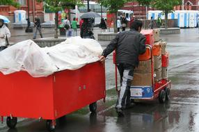 salesman with red carts on a city street