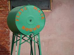 Green and orange fuel tank near the building, on the Route 66
