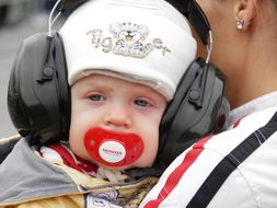 Portrait of the kid in headphones, with the parent