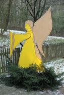 Yellow Christmas Angel figure on Fir tree