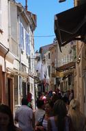 People on the beautiful street of St Tropez, France, under the blue sky