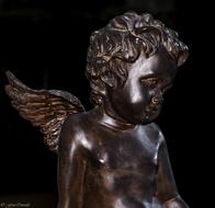 Shiny figure of the angel, at black background