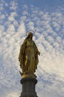 evening clouds over the statue of mary