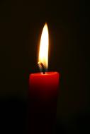 Red Candle at Black