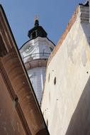Tower among the other buildings in VeszprÃ©m, Hungary, under the blue sky