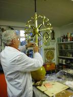 Man plating chapel cross with gold