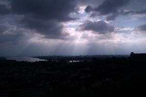 sun behind the clouds over the lake in the evening