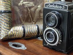 vintage camera on the table next to the painting