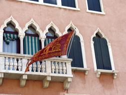 flag on the balcony of the building near the windows