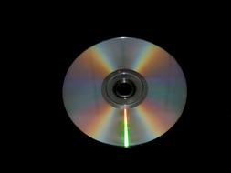 shiny cd disc on black surface