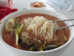 Close-up of the beautiful and colorful Kongguksu, with chopsticks