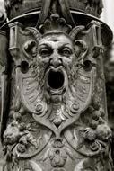 Black and white photo with close-up of the gothic face with patterns on the statue