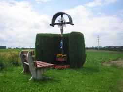 cross, bush and bench