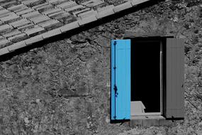 Window with blue and grey shutters, in the building, in black and white colors