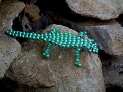 braided lizard from beads on stone