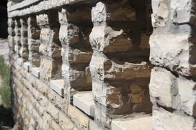 Stone columns in the wall, in sunlight