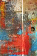 splashes of bright paints on a wooden door