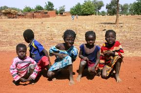 Children on landscape, near the plants and buildings, in Nanoro, Burkina Faso, Africa