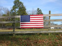 american flag on wooden fence