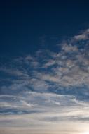 Grey and white clouds in the blue sky with sunlight