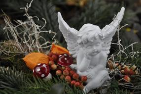 figurine of a sad angel in a forest landscape