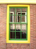 yellow window with green frame in Amsterdam