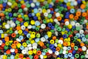 Macro photo of the colorful, shiny beads in the pile